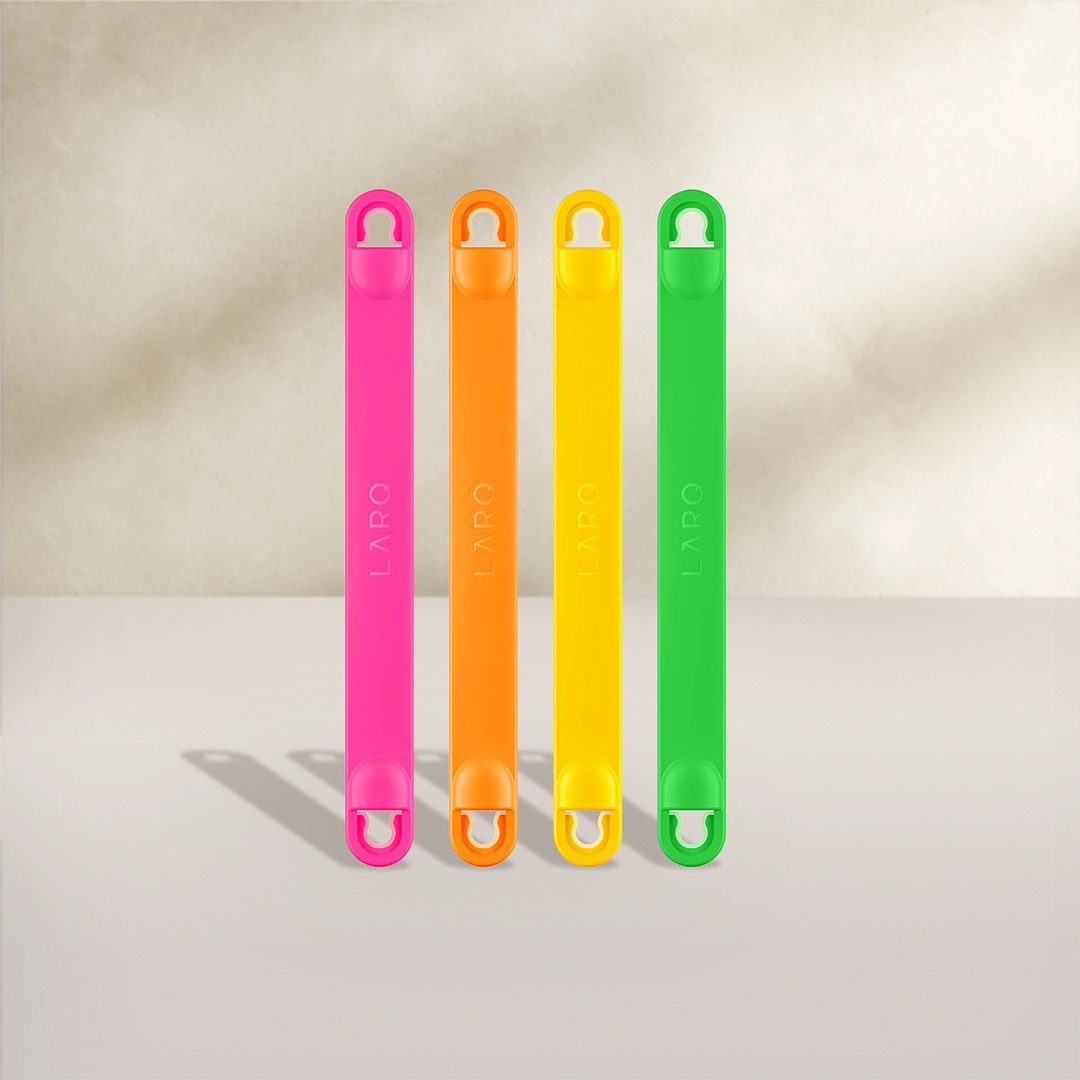 BRITA LARQ Bottle Handles in four colors: pink, orange, yellow, and green on a beige background.