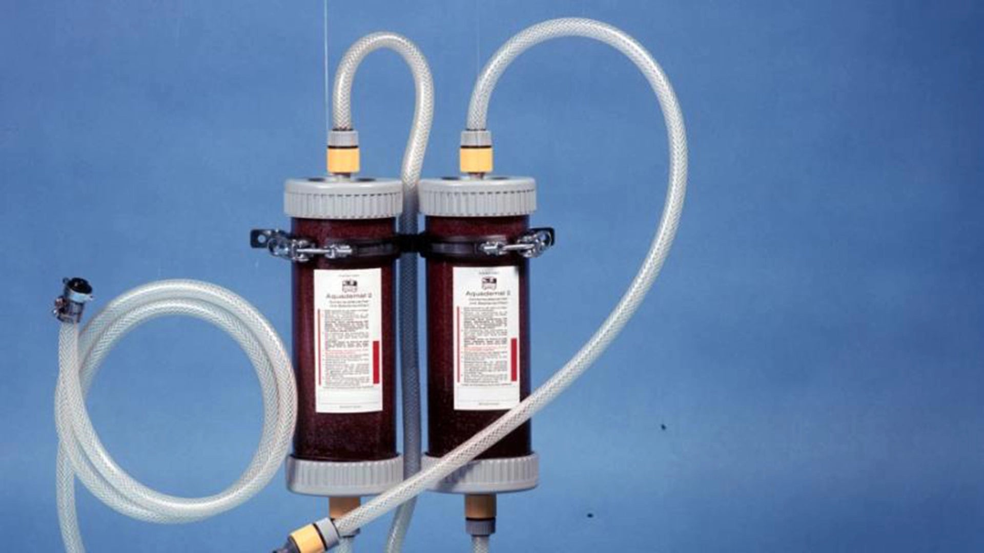 BRITA Aquademat filter units with hoses on blue background.